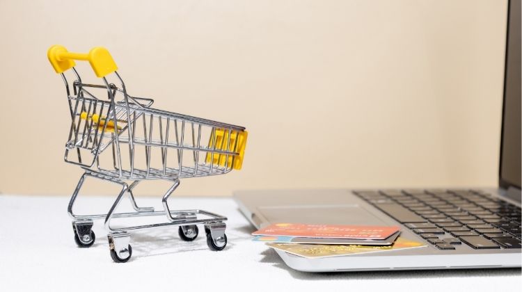 Shopping cart next to laptop